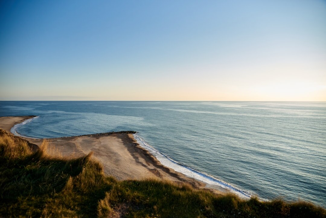 Atmospheric golden hour landscape photo of a Danish coastline with soft fog