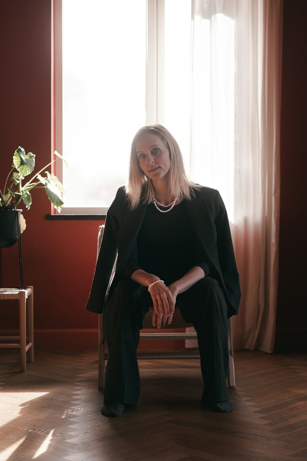 Studio portrait of a young Danish woman with natural light and neutral background