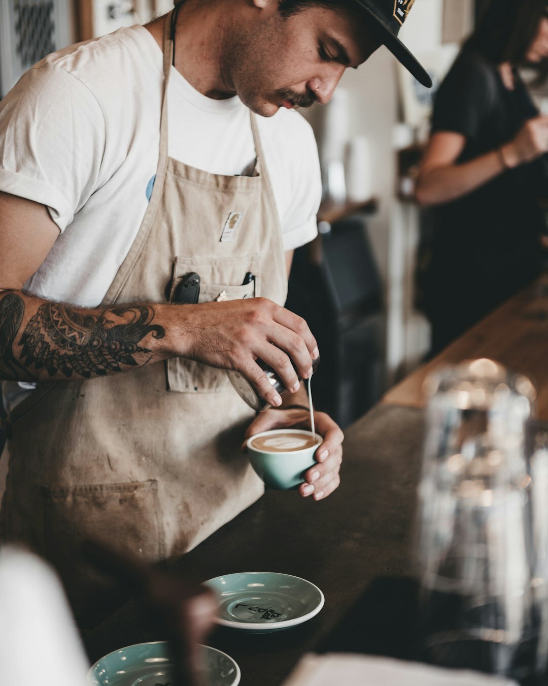Barista preparing coffee in a small Danish cafe for a brand shoot
