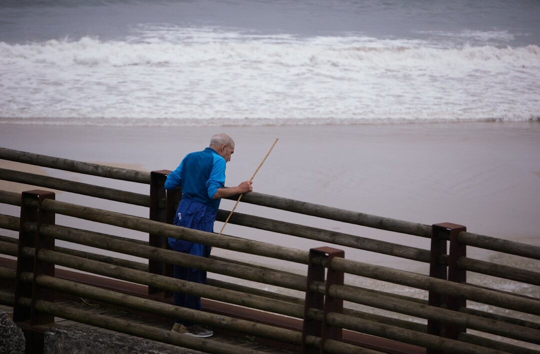 elderly man fishing by sea